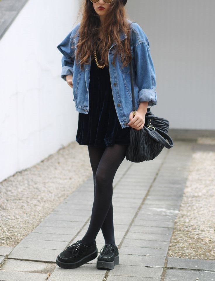 Woman wearing blue Denim Jacket Over An All-Black Or Monochromatic Black Outfit